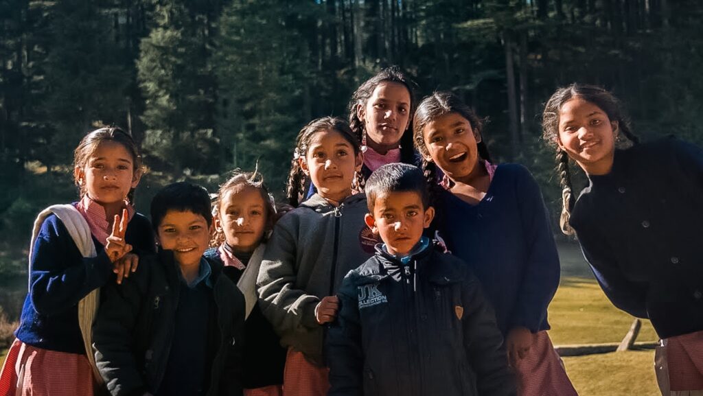 A bunch of Himachali school kids smiling in front of the camera
